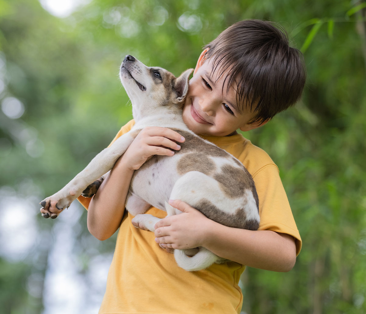 lawn pest control with your family and pets in mind image of a child with a small dog